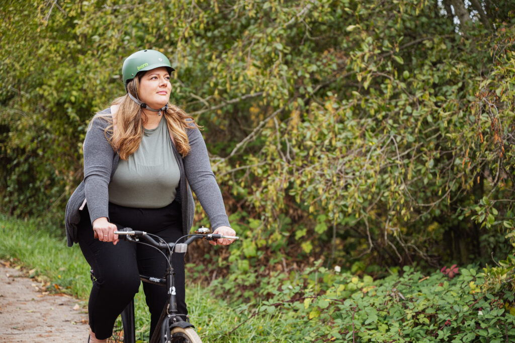 Woman bike on bike path in the fall.